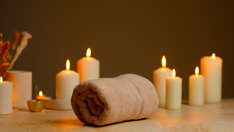 Still-Life-Of-Lit-Candles-With-Dried-Grasses-Incense-Stick-And-Soft-Towels-As-Part-Of-Relaxing-Spa-Day-Decor-9